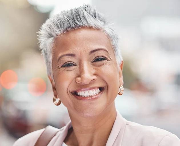 The lady smiling confidently after the dental implants procedure in Oklahoma City, OK